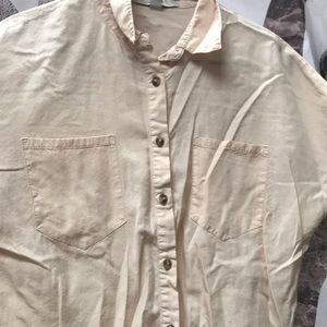 Cream colored crop top with pockets